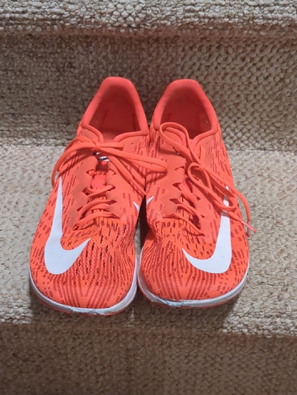 Nike Air Zoom Streak LT 4 running shoes in the vibrant "Laser Crimson" colorway